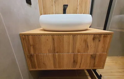 Cabinet in the bathroom. Hanging bedside table under the washbasin